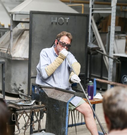 Photo of Adam Aaronson demonstrating glass blowing.